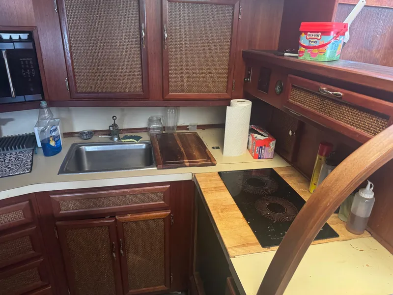 Slide: The Image of 1983 Viking 41 Convertible kitchen with wooden cabinets, sink, and electric stove. - 4