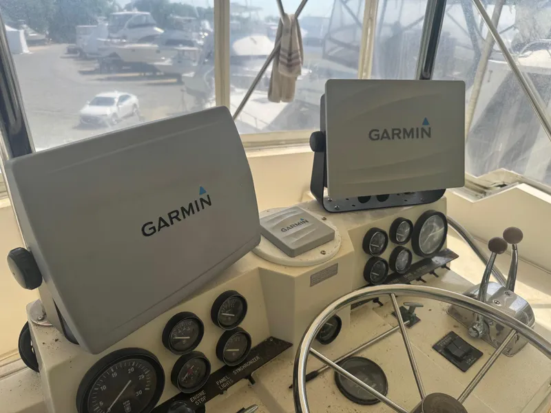 Slide: The Image of Helm of 1983 Viking 41 Convertible with Garmin navigation displays and gauges. - 6