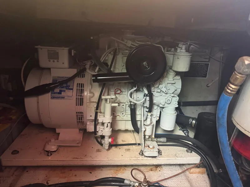 Slide: The Image of Engine compartment of a 1983 Viking 41 Convertible boat, showcasing mechanical components. - 7