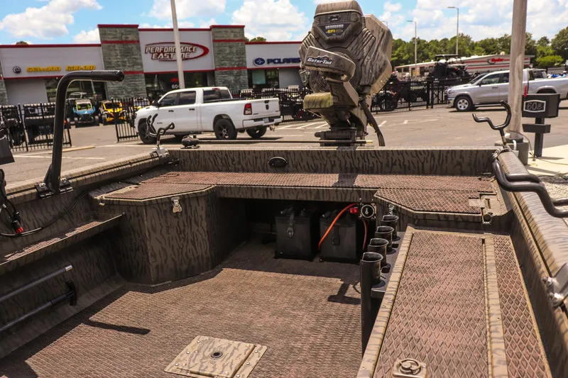 Slide: The Image of 2022 Gator Tail 1860 Extreme Mod V boat with camo design, parked at dealership. - 10