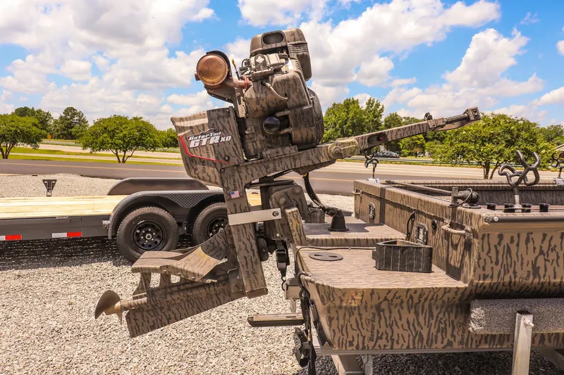 Slide: The Image of 2022 Gator Tail 1860 Extreme Mod V boat with camo design and powerful motor. - 14