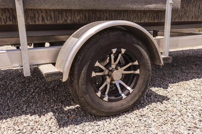 Slide: The Image of Trailer wheel of 2022 Gator Tail 1860 Extreme Mod V on gravel surface. - 15
