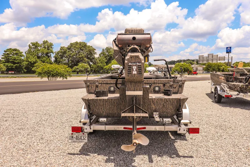 Slide: The Image of 2022 Gator Tail 1860 Extreme Mod V boat on trailer, parked outdoors under blue sky. - 4