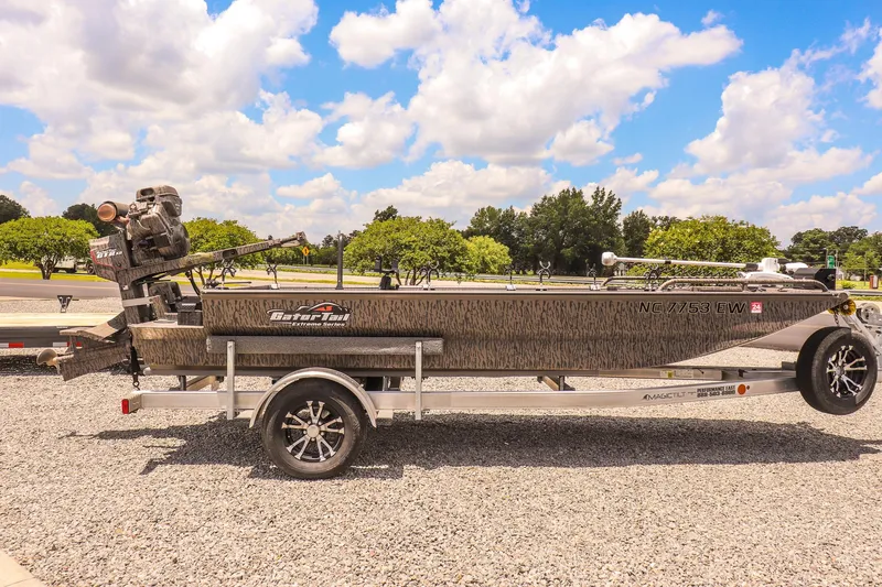 Slide: The Image of 2022 Gator Tail 1860 Extreme Mod V boat on trailer under a blue sky. - 6