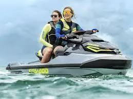 Slide: The Image of 2025 Sea-Doo RXT-X 325 jet ski with two riders on the ocean. - 7