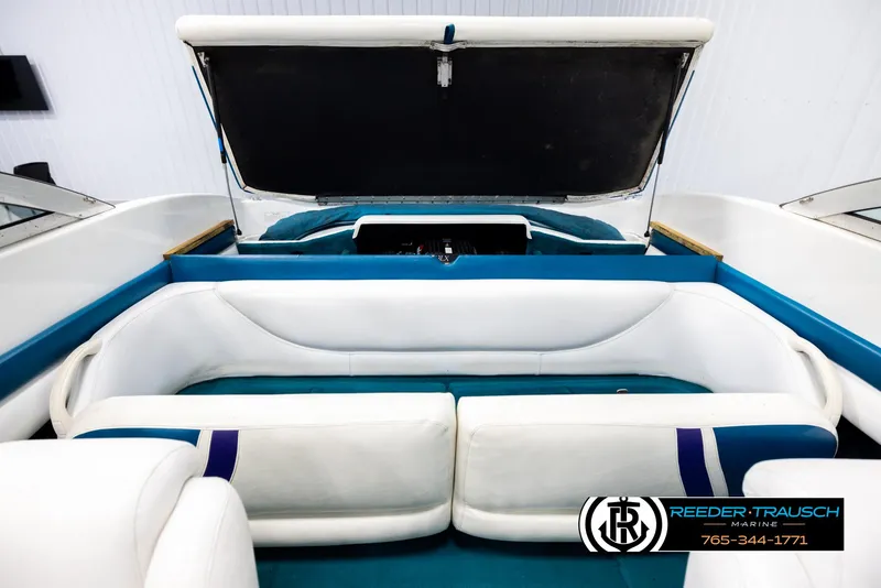 Slide: The Image of Interior of a 1997 Celebrity 190 boat with white and blue seating. - 20