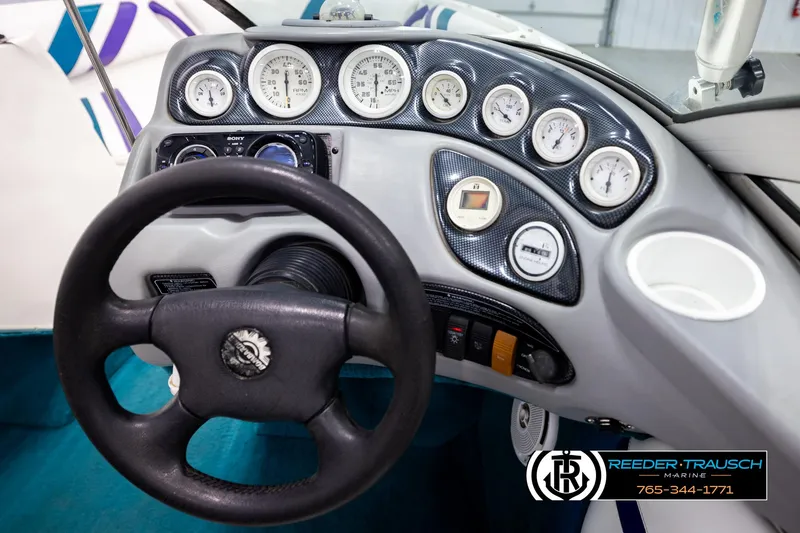 Slide: The Image of Steering wheel and dashboard of a 1997 Celebrity 190 boat with gauges and controls. - 21