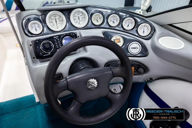 Slide: The Image of Dashboard of a 1997 Celebrity 190 boat with gauges and steering wheel. - 22