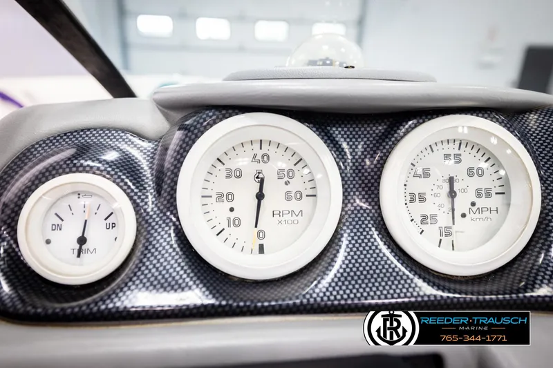 Slide: The Image of Dashboard of a 1997 Celebrity 190 boat with RPM and speed gauges. - 26