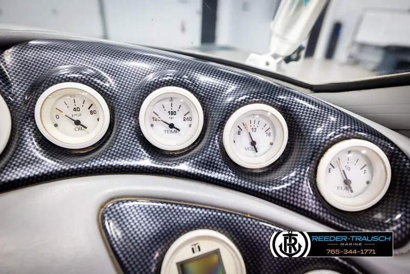 Slide: The Image of Dashboard gauges of a 1997 Celebrity 190 boat, featuring oil, temperature, volt, and fuel indicators. - 27