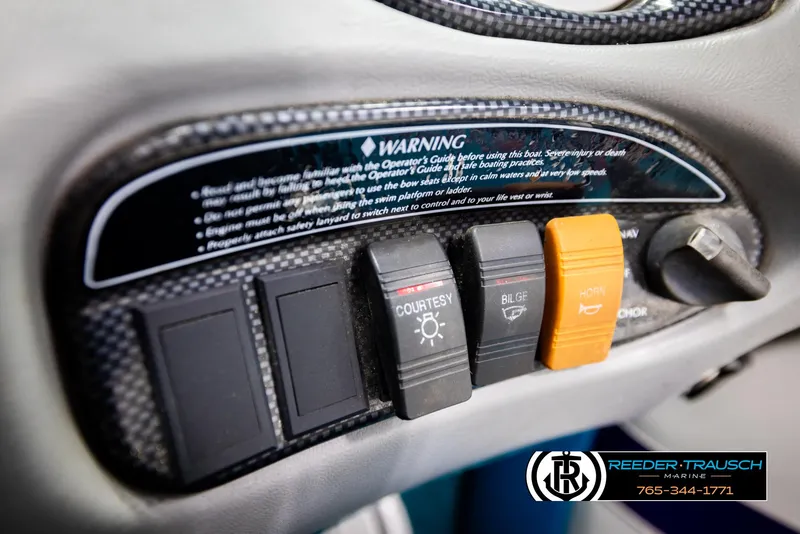 Slide: The Image of Control panel of a 1997 Celebrity 190 boat with warning label and switches. - 30