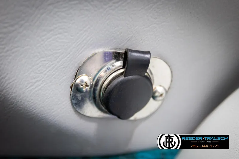 Slide: The Image of Power outlet on a 1997 Celebrity 190 boat interior, featuring a protective cover. - 31