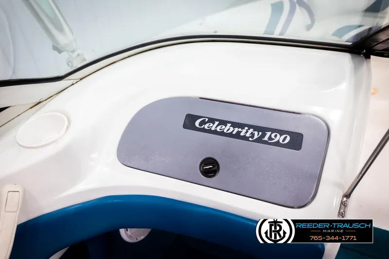Slide: The Image of 1997 Celebrity 190 boat dashboard with logo, featuring sleek white and blue design. - 34