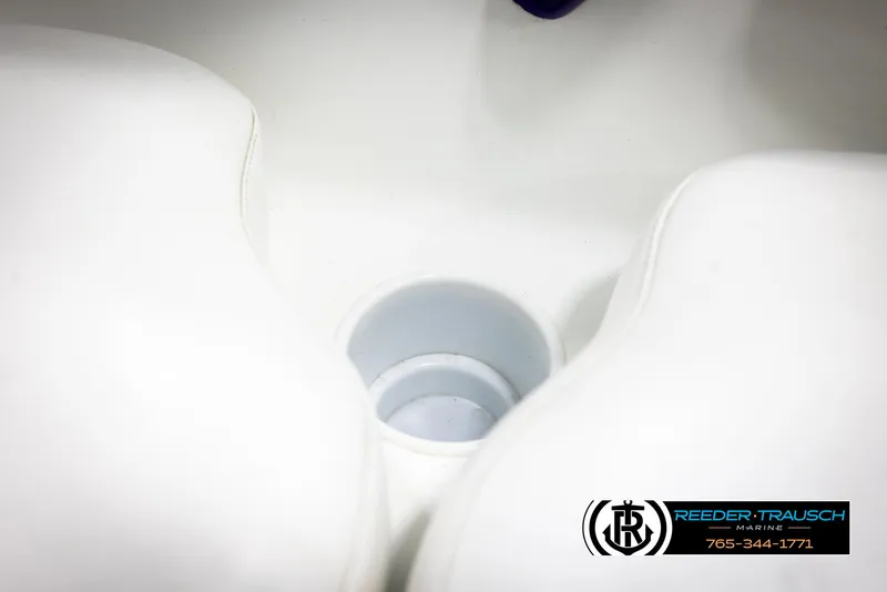 Slide: The Image of White boat interior with cup holder, featuring Reeder-Trausch Marine logo. - 39