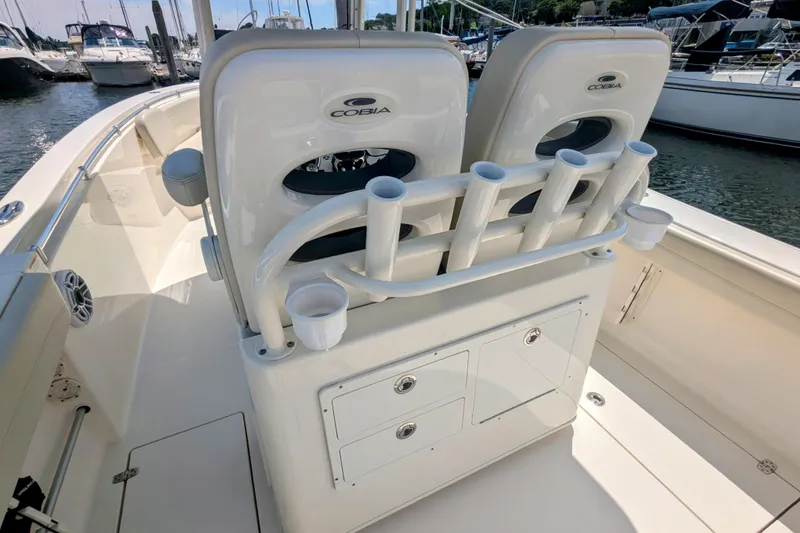 Slide: The Image of 2023 Cobia 280 Center Console boat interior with rod holders and storage compartments. - 12