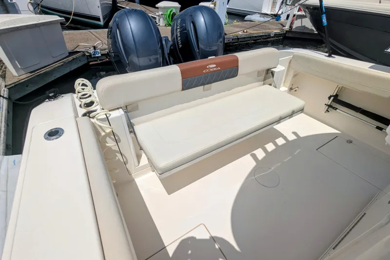 Slide: The Image of 2023 Cobia 280 Center Console boat interior with seating and dual Yamaha engines. - 15