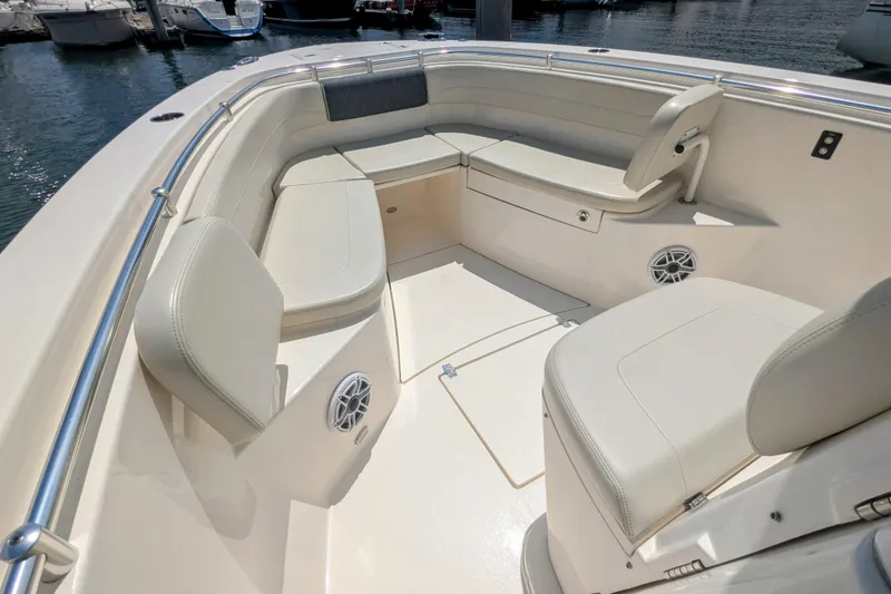 Slide: The Image of 2023 Cobia 280 Center Console boat interior with cushioned seating and speakers. - 19