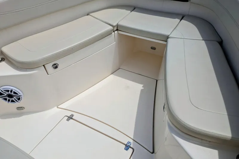 Slide: The Image of 2023 Cobia 280 Center Console boat seating area with storage compartments. - 23