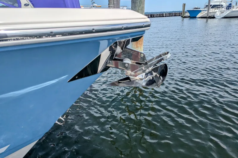 Slide: The Image of 2023 Cobia 280 Center Console boat with anchor, docked in marina. - 30
