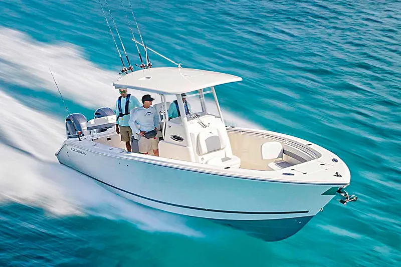 Slide: The Image of Manufacturer Provided Image: 2023 Cobia 280 Center Console boat cruising on clear blue water. - 31