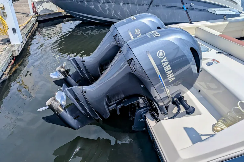 Slide: The Image of 2023 Cobia 280 Center Console with twin Yamaha outboard motors at dock. - 6