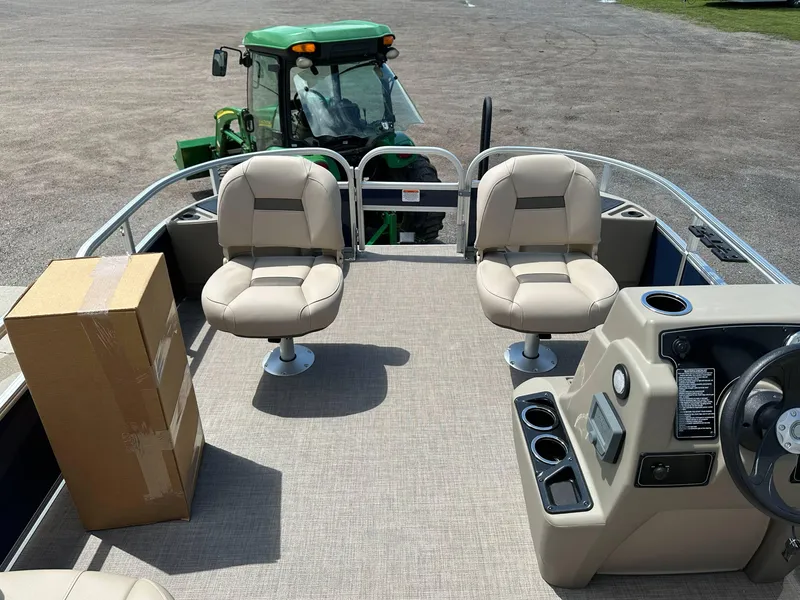 Slide: The Image of 2025 Sun Tracker Bass Buggy 18 DLX pontoon boat interior with seats and steering console. - 12