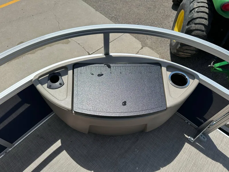 Slide: The Image of 2025 Sun Tracker Bass Buggy 18 DLX boat deck with cup holders and storage compartment. - 24