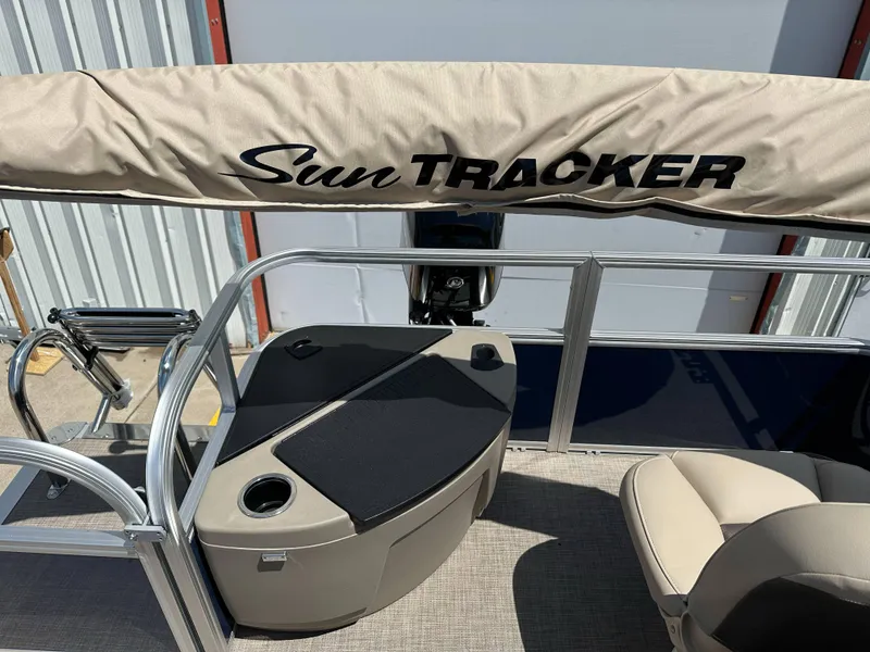 Slide: The Image of 2025 Sun Tracker Bass Buggy 18 DLX pontoon boat interior with seating and storage. - 26