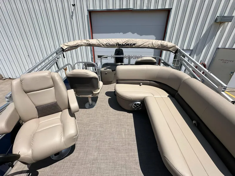 Slide: The Image of 2025 Sun Tracker Bass Buggy 18 DLX pontoon boat with beige seating and spacious layout. - 30