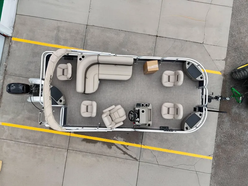 Slide: The Image of 2025 Sun Tracker Bass Buggy 18 DLX pontoon boat, aerial view, beige seating, docked. - 31