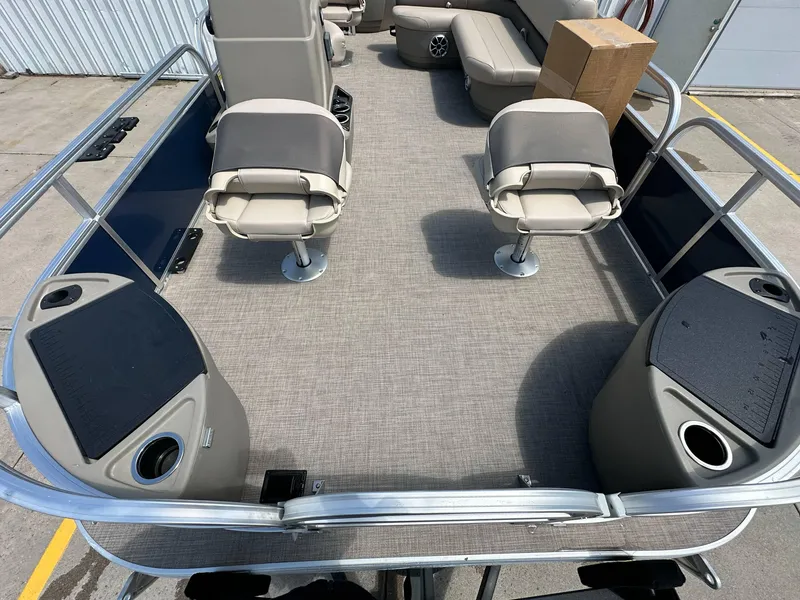 Slide: The Image of 2025 Sun Tracker Bass Buggy 18 DLX pontoon boat interior with seating and storage compartments. - 8