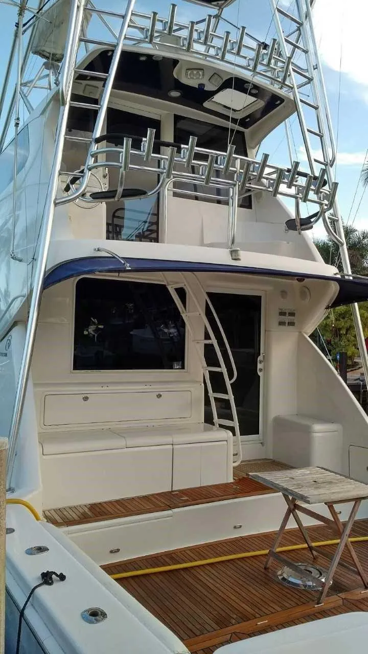 Slide: The Image of 2004 Riviera 58 Enclosed Flybridge yacht with spacious deck and flybridge. - 20