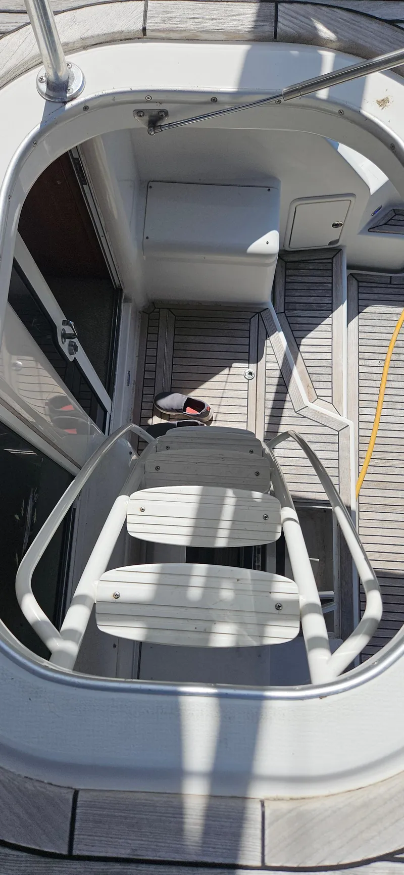 Slide: The Image of Staircase on 2004 Riviera 58 Enclosed Flybridge yacht, featuring sleek design and wooden deck. - 22
