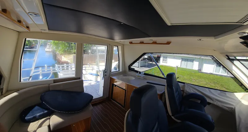 Slide: The Image of Interior of 2004 Riviera 58 Enclosed Flybridge yacht with seating and large windows. - 25
