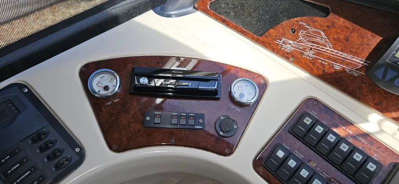 Slide: The Image of Control panel of 2004 Riviera 58 Enclosed Flybridge with gauges and switches. - 33