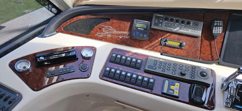 Slide: The Image of Control panel of a 2004 Riviera 58 Enclosed Flybridge yacht with navigation instruments. - 34