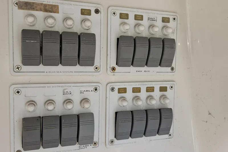 Slide: The Image of Control panel of a 2004 Riviera 58 Enclosed Flybridge with switches and labels. - 35