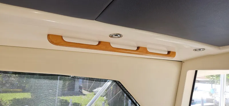 Slide: The Image of Interior detail of 2004 Riviera 58 Enclosed Flybridge, featuring wood accents and modern lighting. - 36