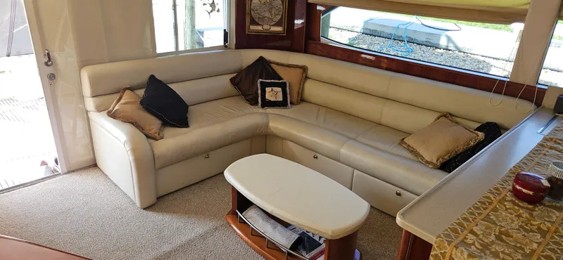 Slide: The Image of Luxurious interior of 2004 Riviera 58 Enclosed Flybridge yacht with cream leather seating and elegant decor. - 40