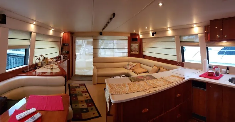 Slide: The Image of Luxurious interior of a 2004 Riviera 58 Enclosed Flybridge yacht with elegant furnishings. - 41