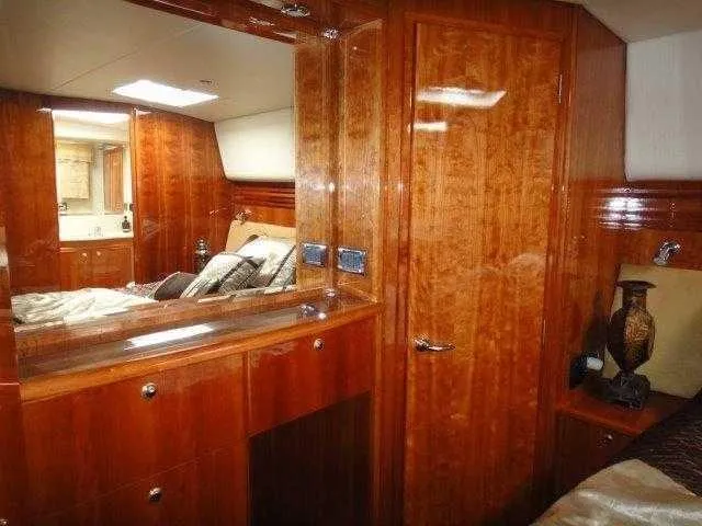 Slide: The Image of Luxurious 2004 Riviera 58 Enclosed Flybridge yacht interior with polished wood finish. - 51