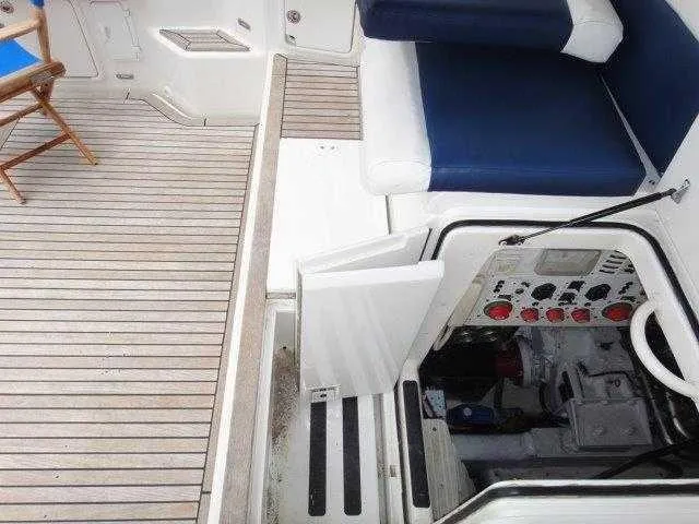 Slide: The Image of 2004 Riviera 58 Enclosed Flybridge boat interior with open engine compartment and seating area. - 61