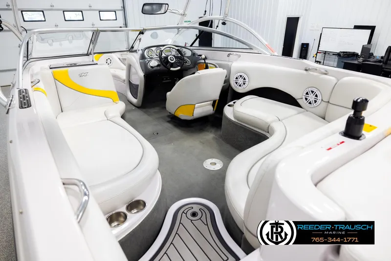 Slide: The Image of Interior of a 2005 Correct Craft 226 Natique boat with white and yellow seating. - 10