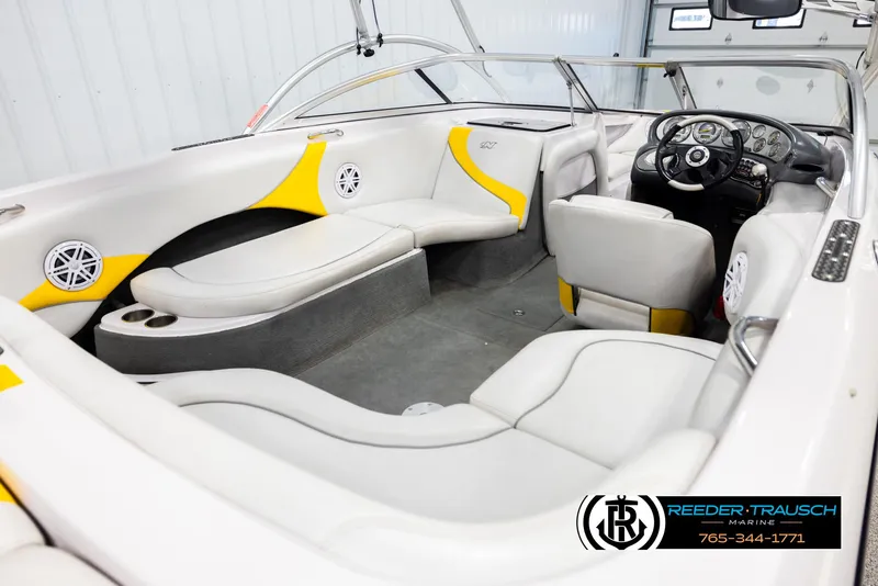 Slide: The Image of 2005 Correct Craft 226 Nautique boat interior with white and yellow seating. - 11