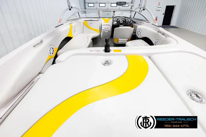 Slide: The Image of 2005 Correct Craft 226 Nautique interior with yellow accents, featuring spacious seating and modern design. - 12