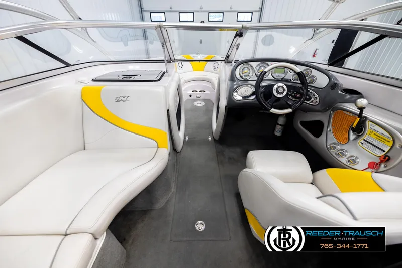 Slide: The Image of Interior of a 2005 Correct Craft 226 Natique boat with white and yellow seating. - 13