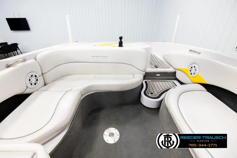 Slide: The Image of 2005 Correct Craft 226 Nautique boat interior with white seating and speaker system. - 18