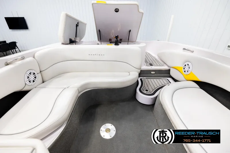 Slide: The Image of Interior of a 2005 Correct Craft 226 Nautique boat with white seating and speakers. - 19