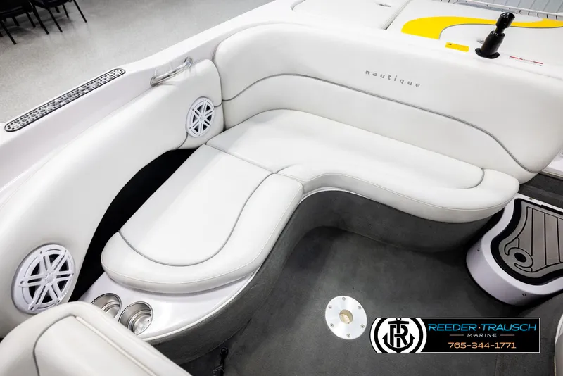 Slide: The Image of 2005 Correct Craft 226 Nautique boat interior with white seating and speaker system. - 20