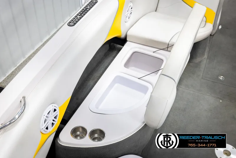 Slide: The Image of 2005 Correct Craft 226 Nautique interior with cup holders and storage compartments. - 25